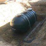 Large Scale Commercial Sewage Treatment System - 5,000 gallon Xerxes commercial pump tank place with anti-buoyancy cables attached.