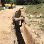 Large Scale Commercial Sewage Treatment System - 7’ deep x 290’ long trench being prepared for multiple gravity and pressurized plumbing to be installed.